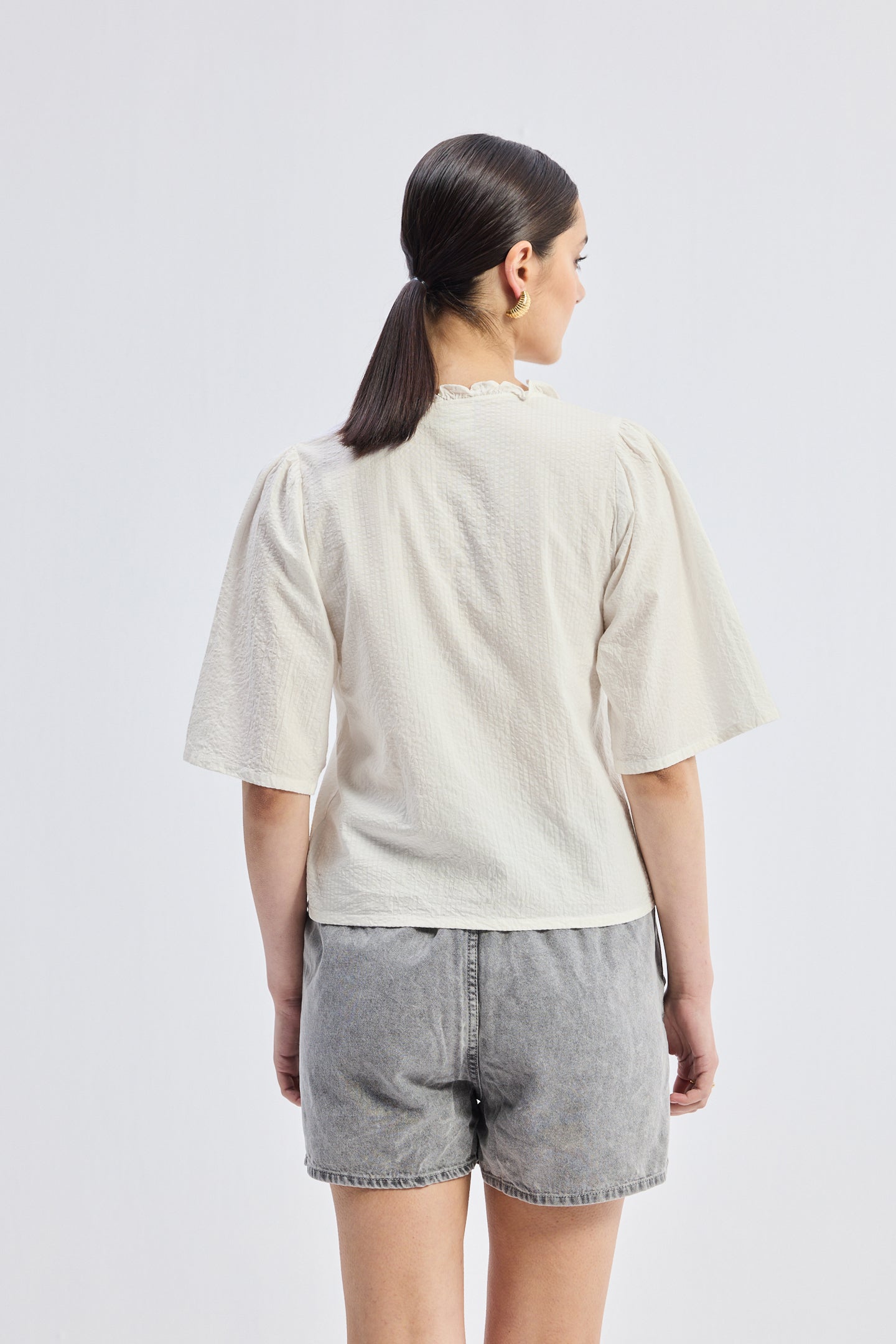 Reistor Relaxed Fit Top With Ruffles and Front-Ties in Cream