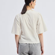 Reistor Relaxed Fit Top With Ruffles and Front-Ties in Cream