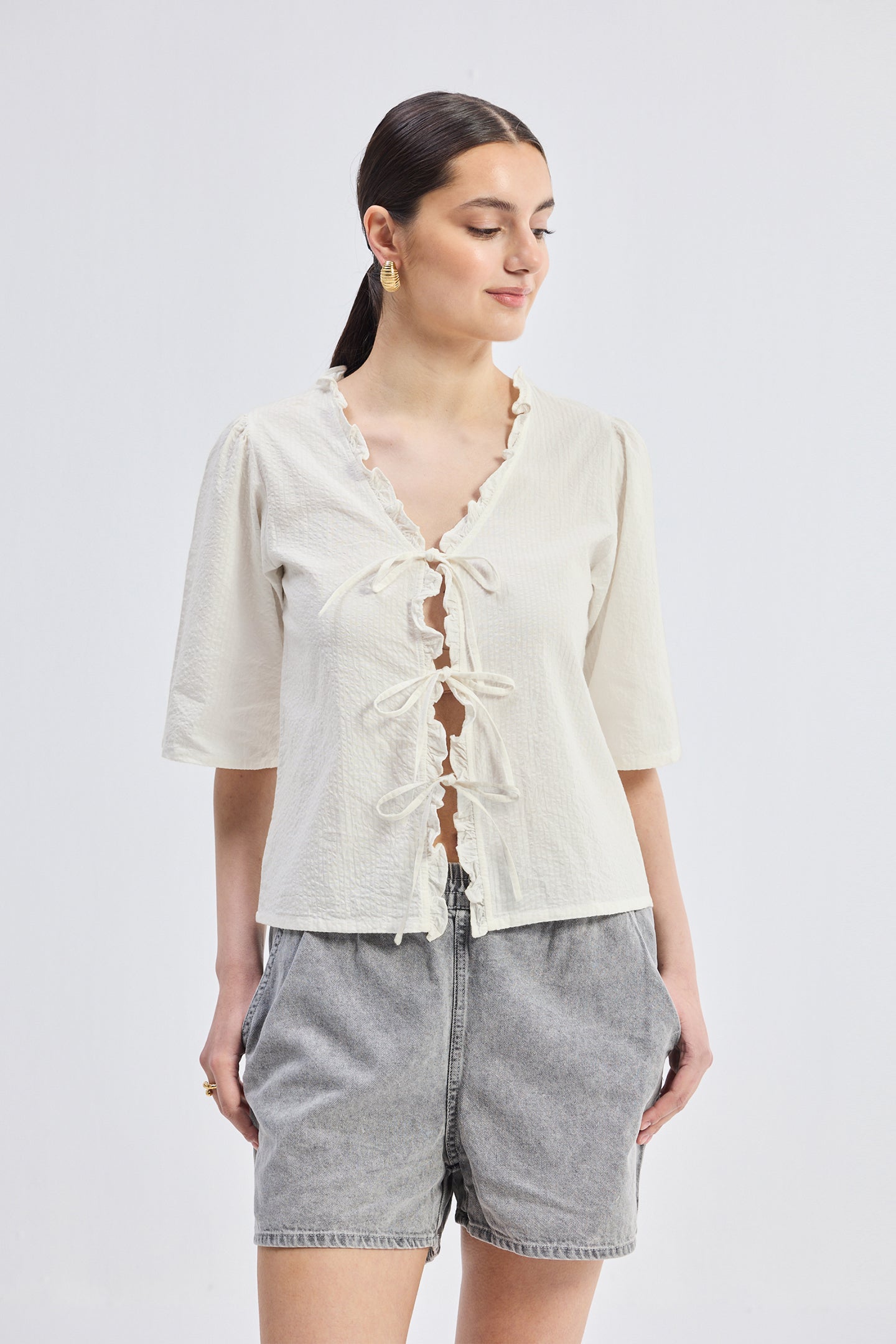 Reistor Relaxed Fit Top With Ruffles and Front-Ties in Cream