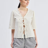 Reistor Relaxed Fit Top With Ruffles and Front-Ties in Cream