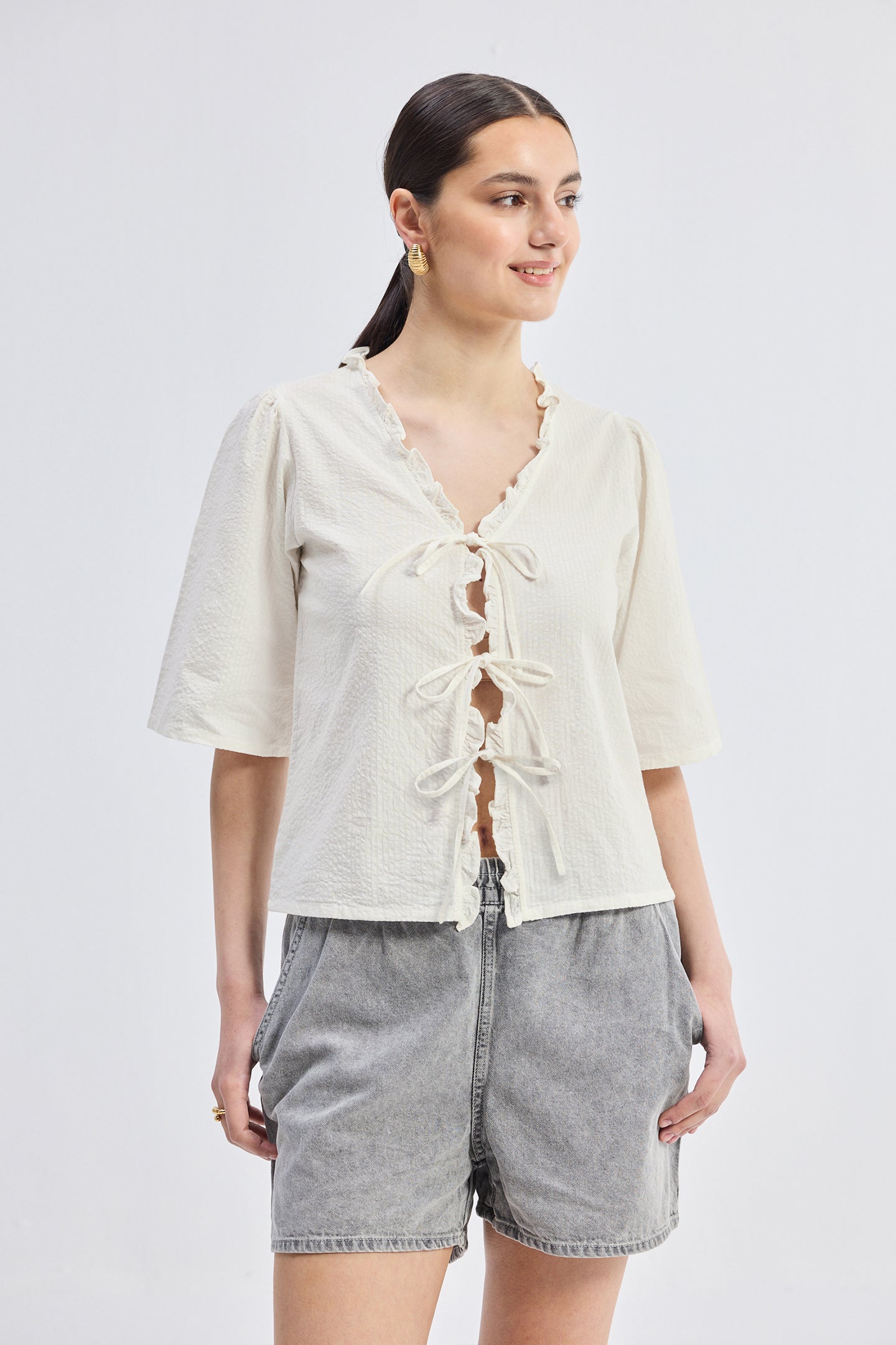 Reistor Relaxed Fit Top With Ruffles and Front-Ties in Cream