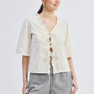 Reistor Relaxed Fit Top With Ruffles and Front-Ties in Cream
