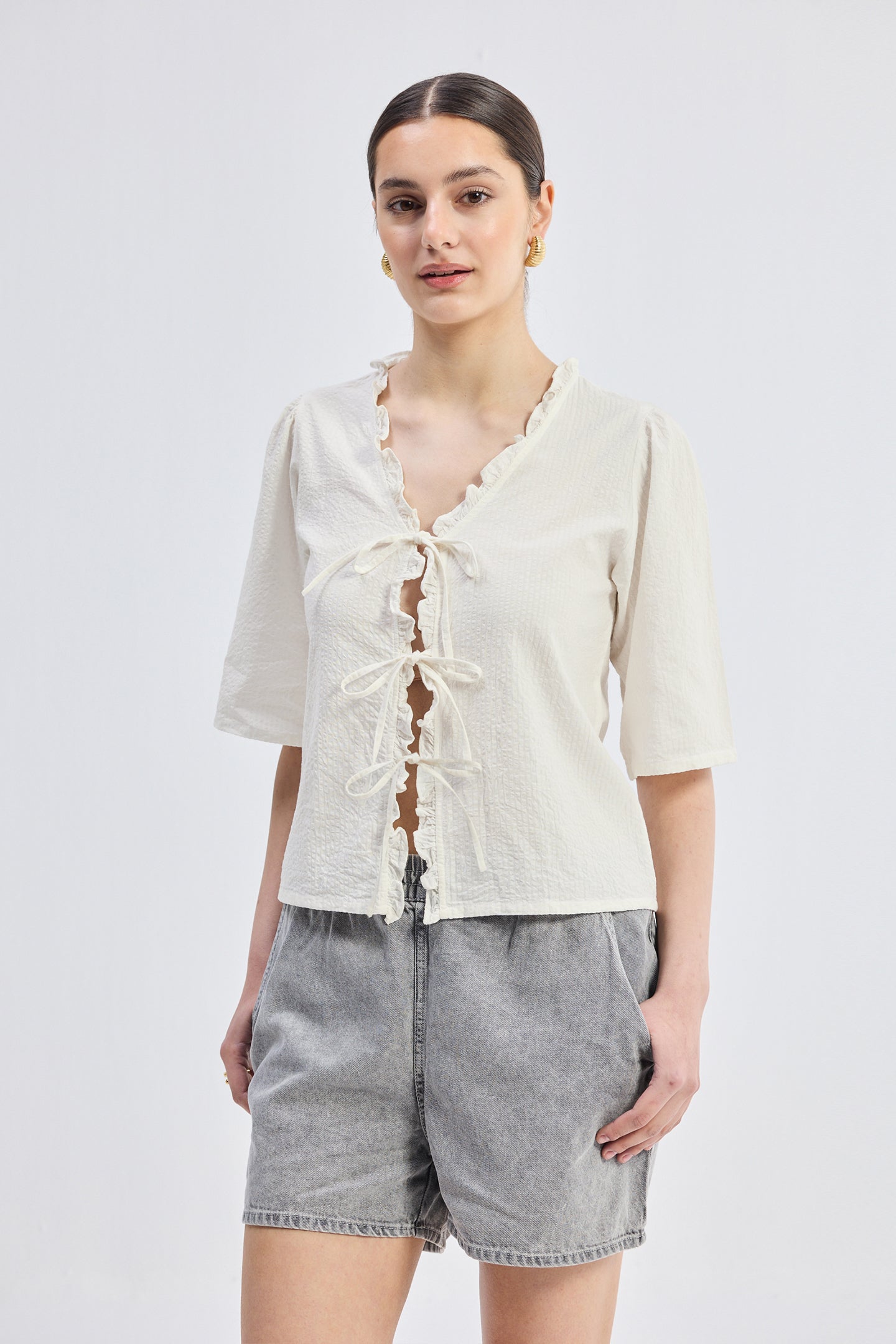 Reistor Relaxed Fit Top With Ruffles and Front-Ties in Cream